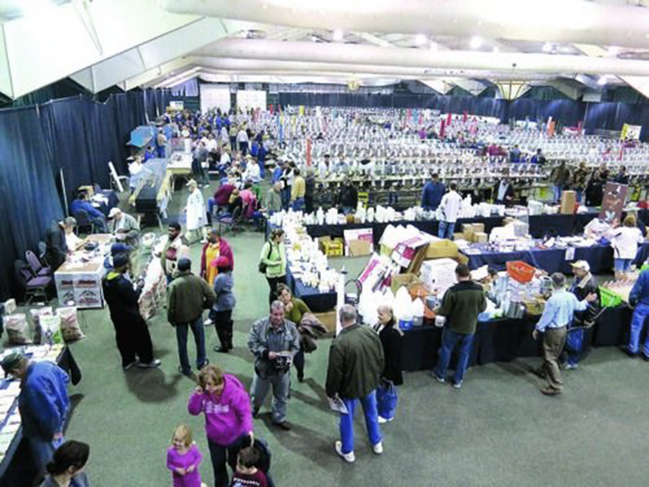 A large group of people at a pigeon show.